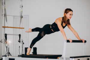 Woman doing pilates on a reformer